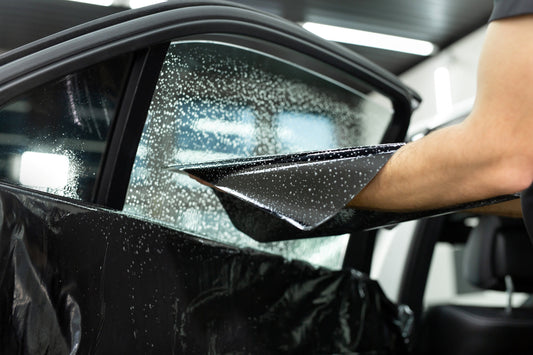 window tint being applied to a car window 